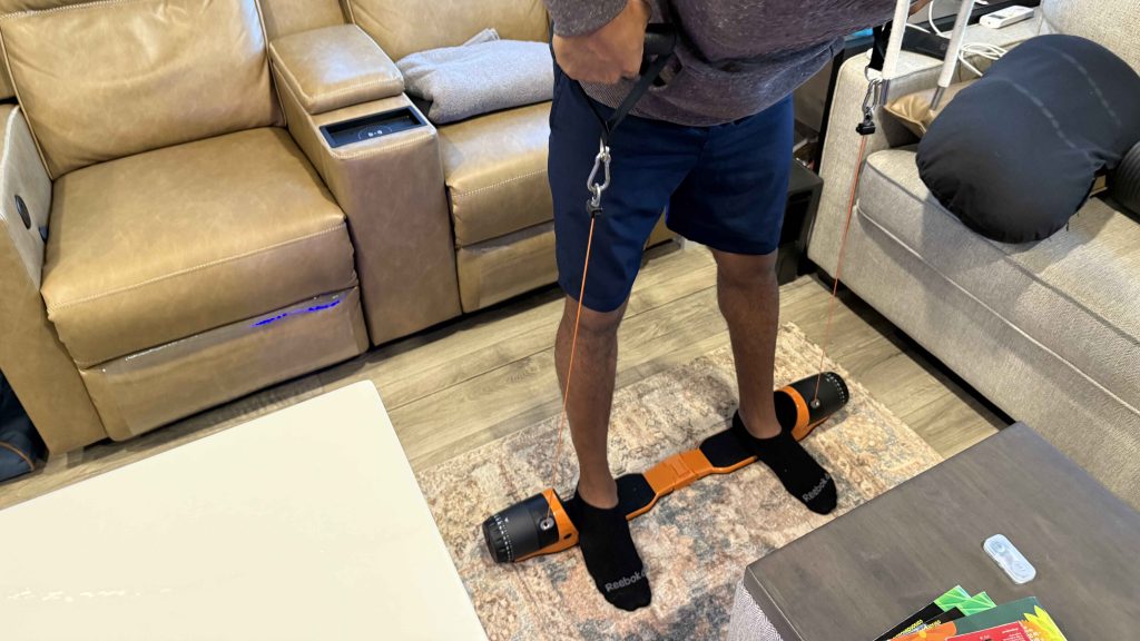 MaxPro Review: My Full-Time RV Gym 2 MaxPro Review: Person using MaxPro resistance trainer for strength workout inside RV